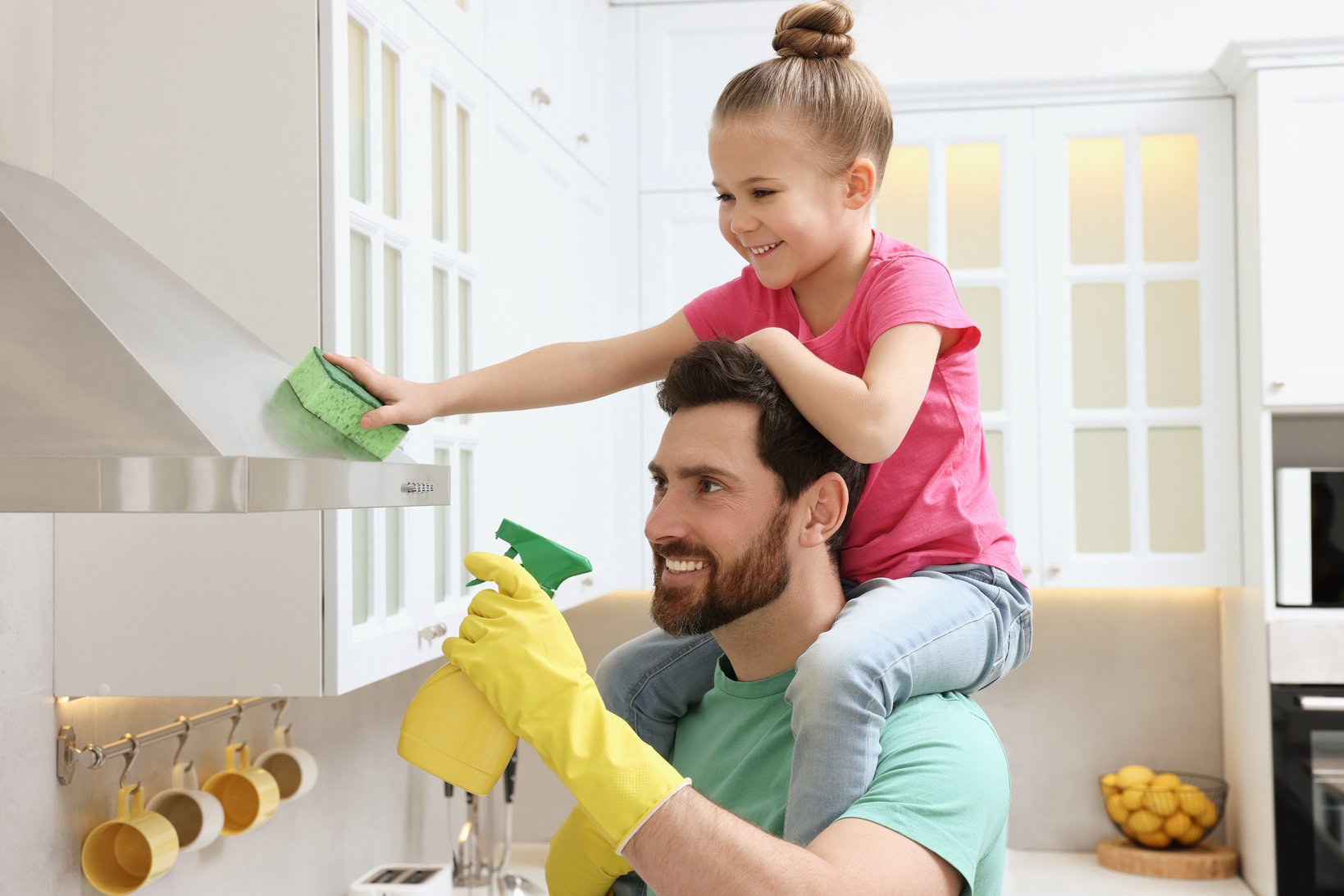 Spring Cleaning. Father and Daughter Tidying up in Kitchen Toget